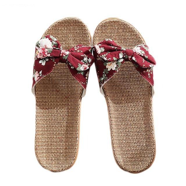Women's woven slide sandals with burgundy floral bow strap and tan base, open toe