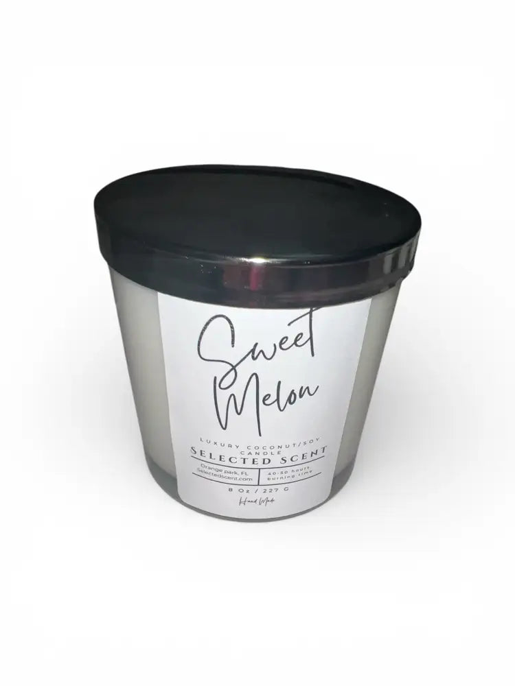 Sweet melon jar candle in clear glass with black lid, no flame visible