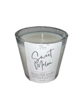 Sweet melon scented candle in clear glass jar with white wax and visible flame