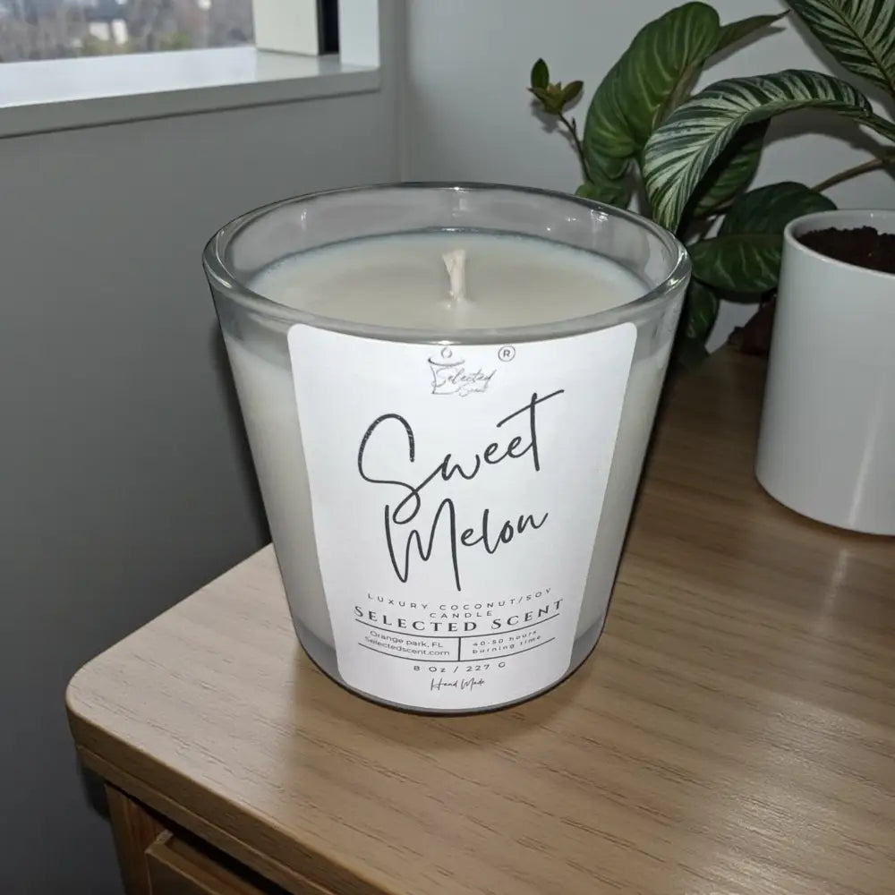 Sweet melon scented candle, clear glass jar with white wax and central flame