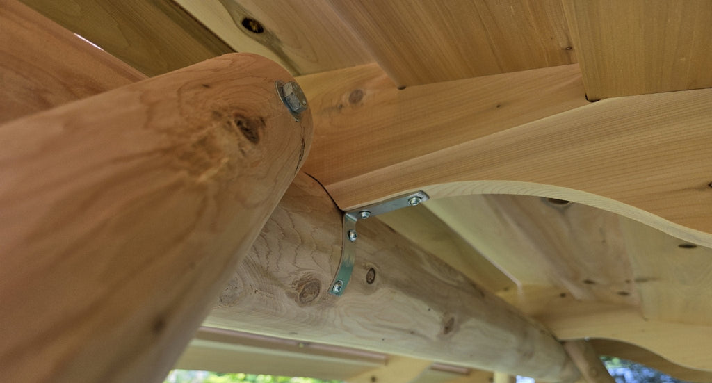 Close-up of metal brackets inside wooden porch swing canopy frame