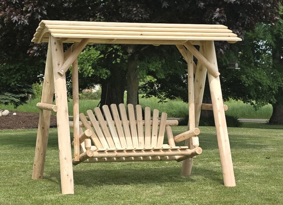 Light wood porch swing with canopy and slatted backrest