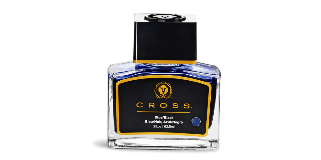 Blue/black fountain pen ink bottle with clear glass body, black cap, gold label