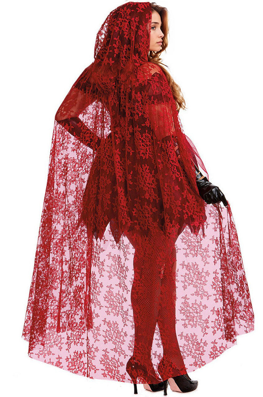 Red patterned hooded cape over black corset and red tulle skirt with fishnet tights