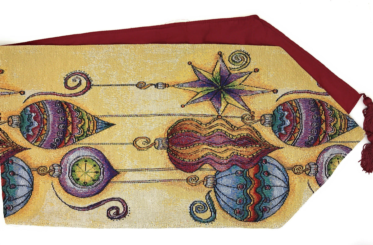 Colorful tapestry table runner detail with lantern faces, star motif, and tassel edge