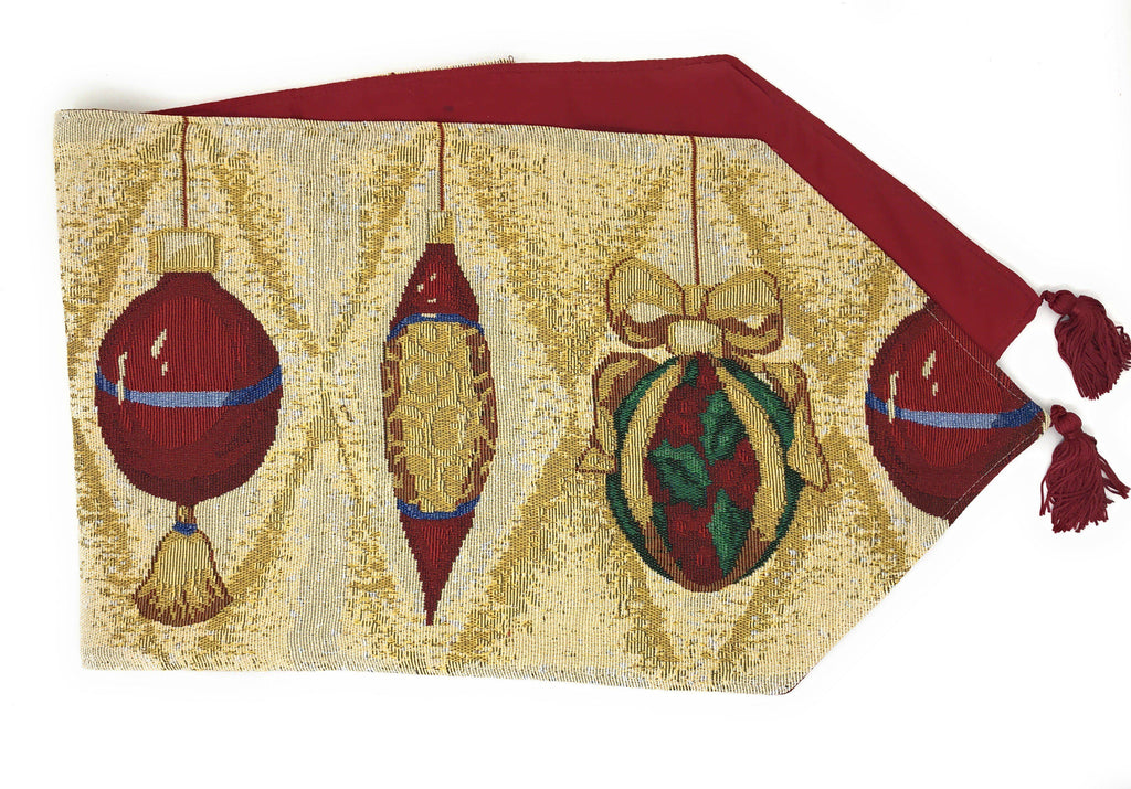 Gold tapestry table runner with red, green Christmas ornament prints and red fringe