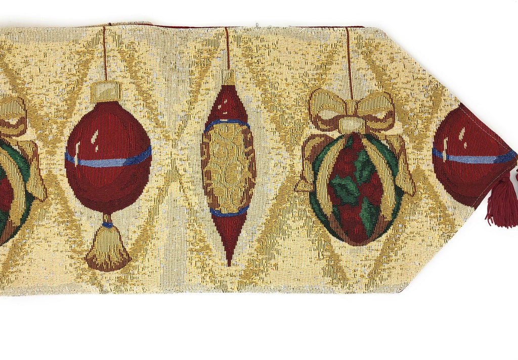 Gold tapestry table runner showing red ornament baubles and green candles, with red fringe