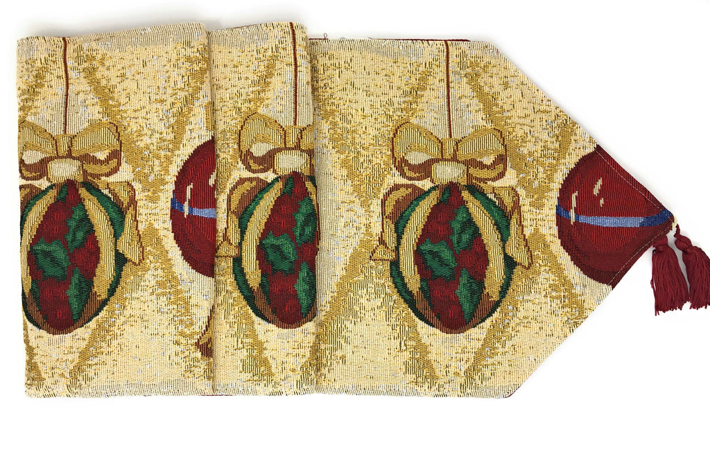 Gold tapestry table runner with bow-tied bauble ornaments in red and green, corner fringe