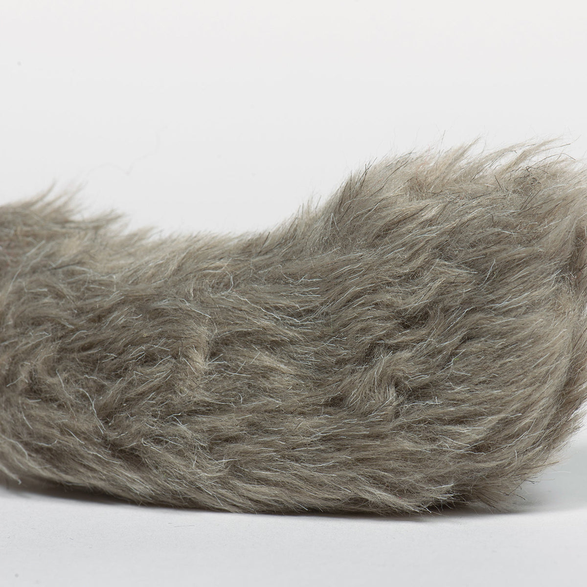Fluffy gray-brown tail end of a plush squirrel dog toy