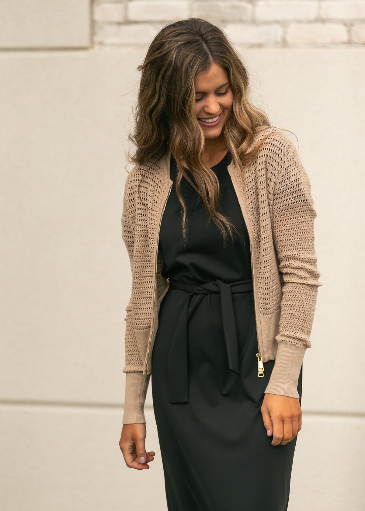 Beige open-knit cardigan with zipper front, long sleeves, and ribbed cuffs and hem.