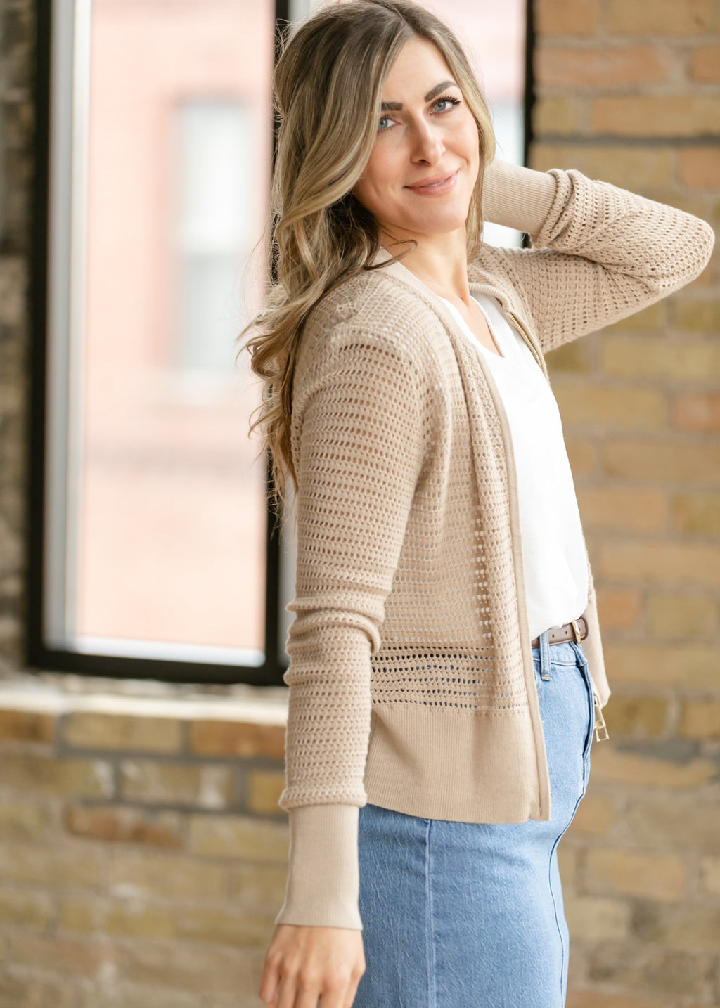 Beige open-knit crochet cardigan with long sleeves and relaxed drape, open front.