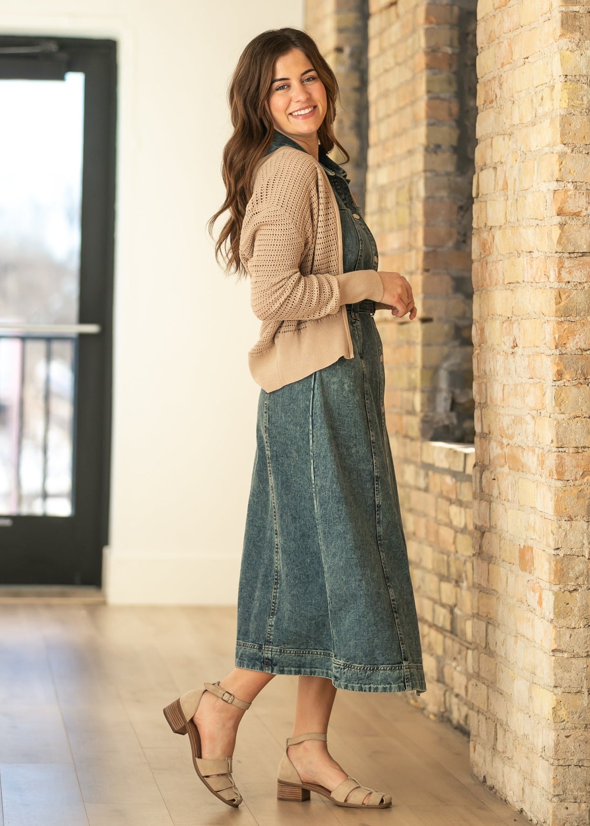 Beige open-knit crochet cardigan with zip-front, styled with a dark denim skirt
