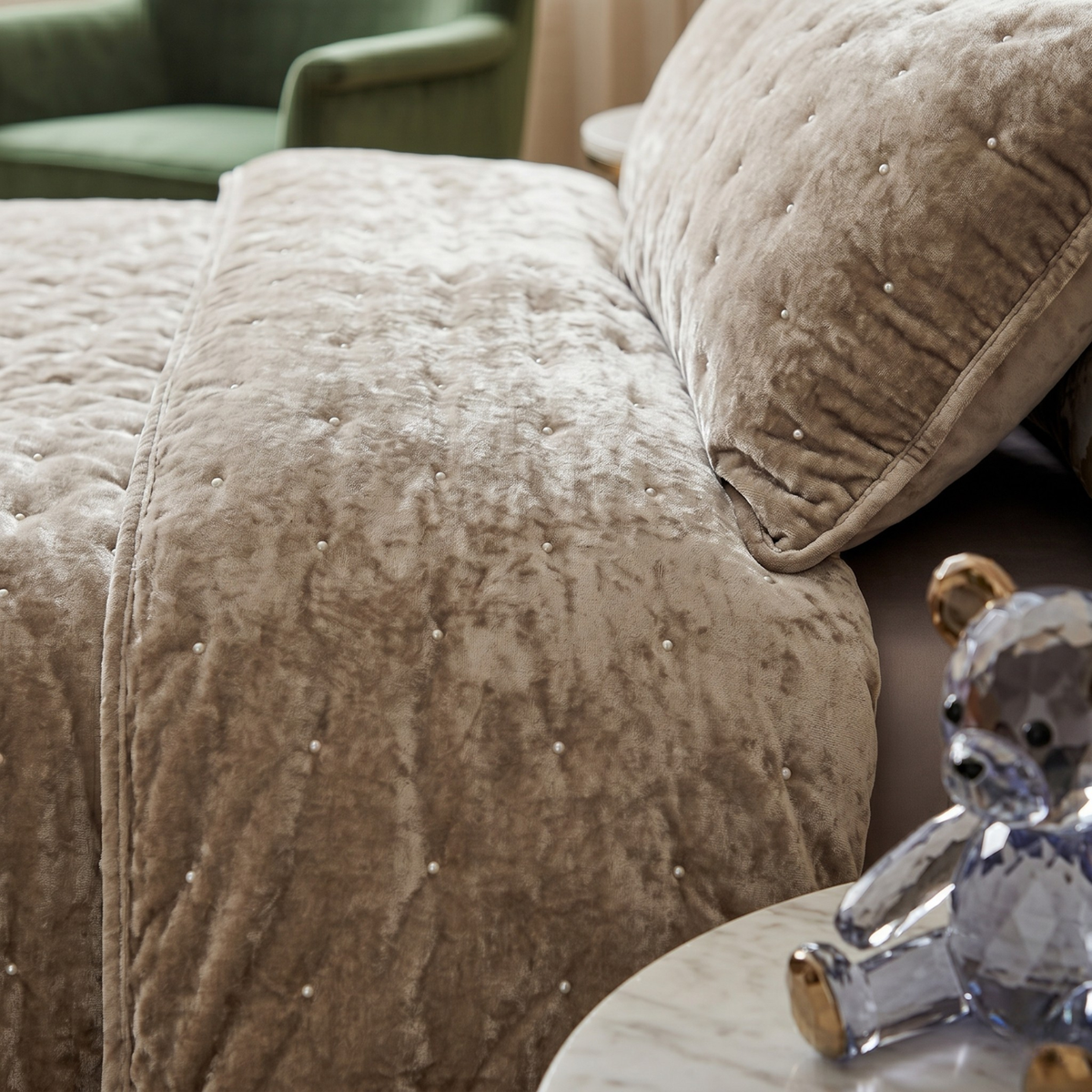Taupe quilt with tufted velvet surface and diamond button details, close view