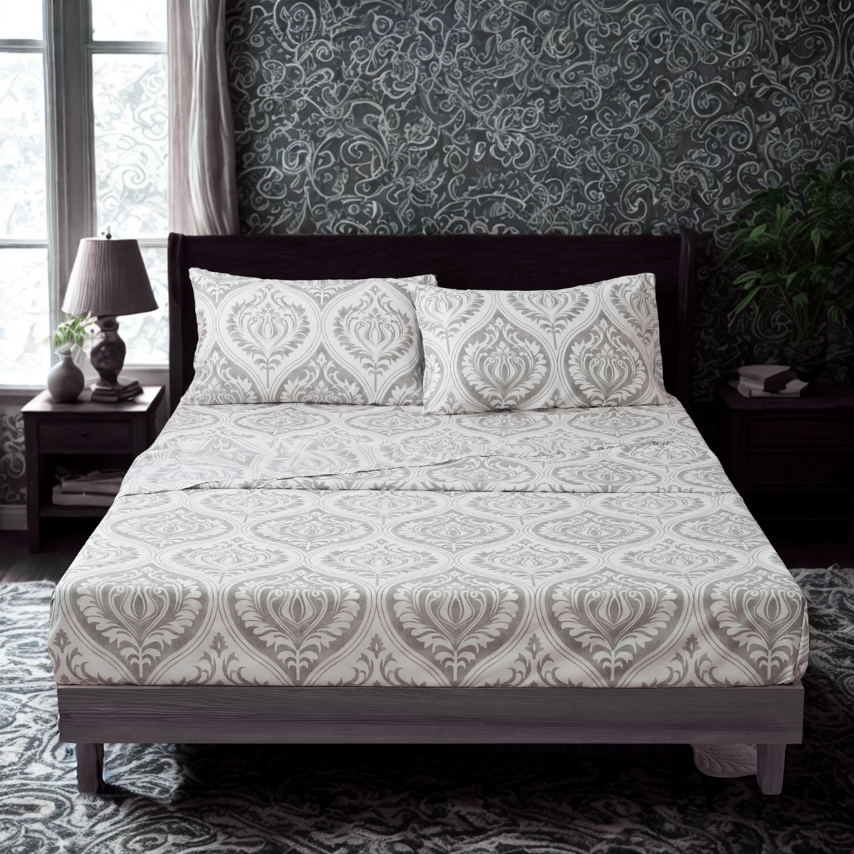 Gray and white damask bed sheet set with two pillowcases on a bed