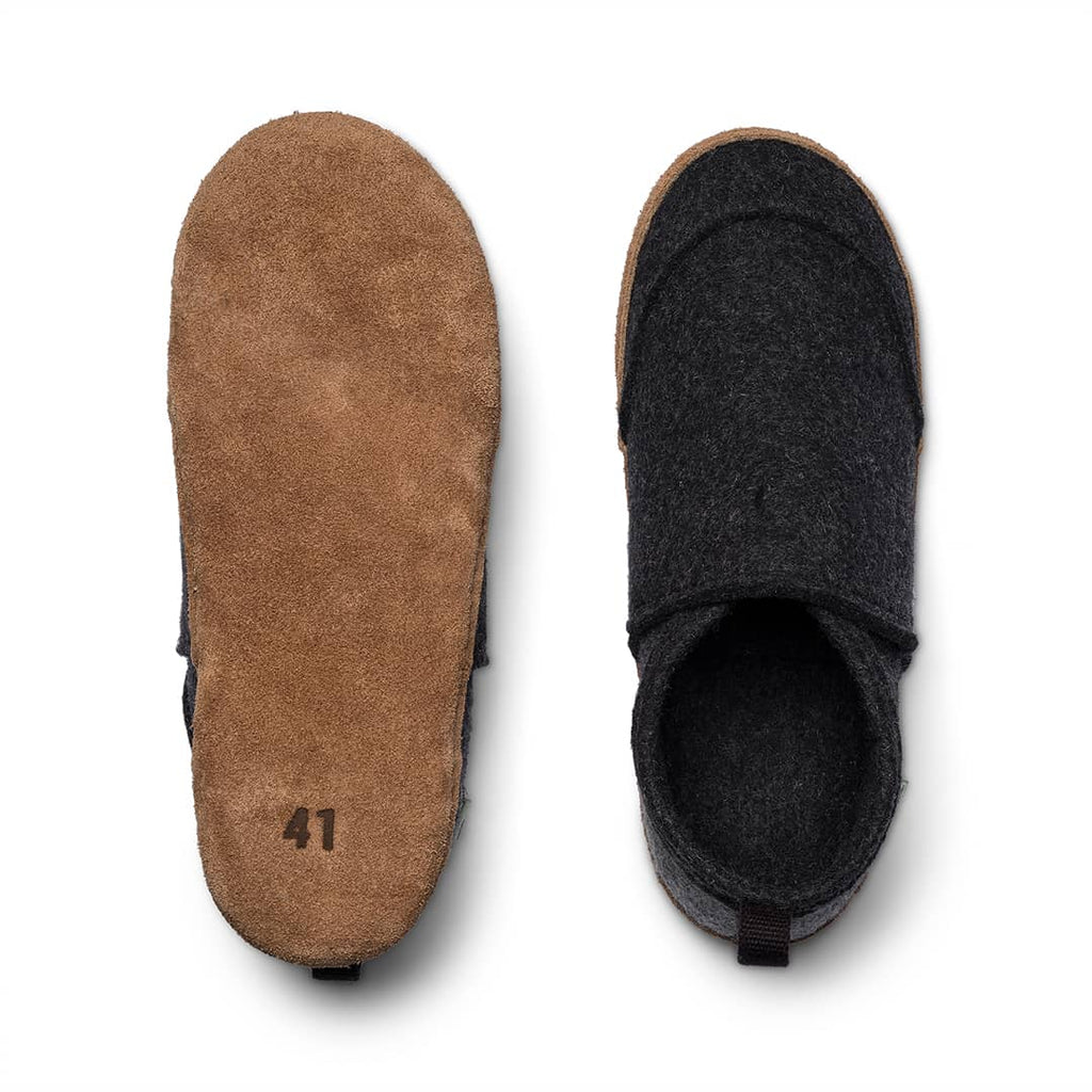 Slip-on slippers with tan exterior and black interior lining