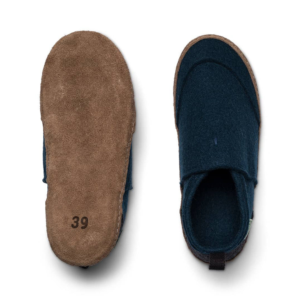 Slip-on slippers showing tan sole and dark blue interior lining