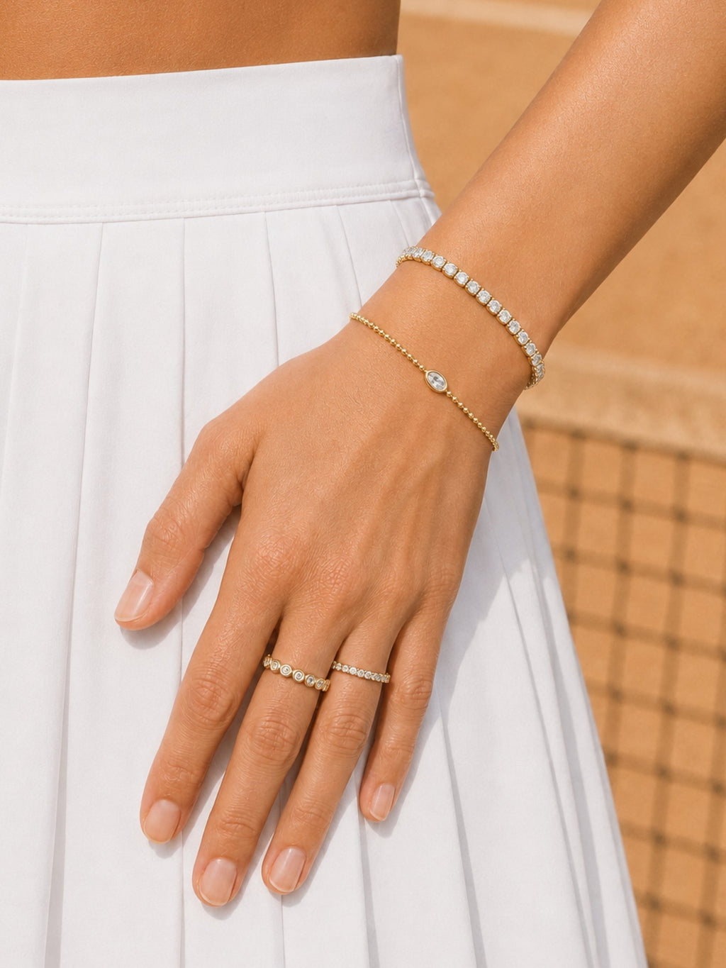 Gold-tone bracelet set with oval stones and beaded detail on the hand