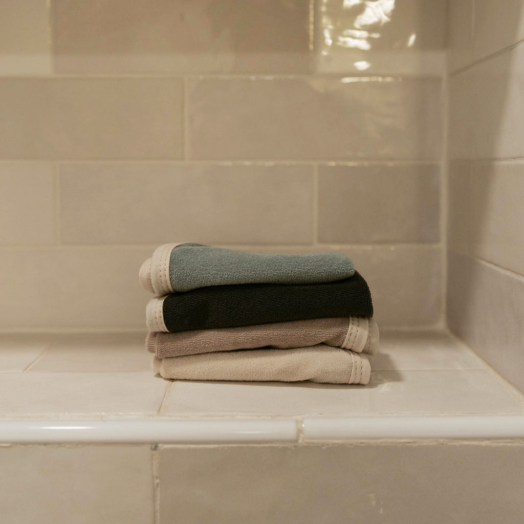 Terry baby washcloth set, folded stack in light gray, dark, and cream
