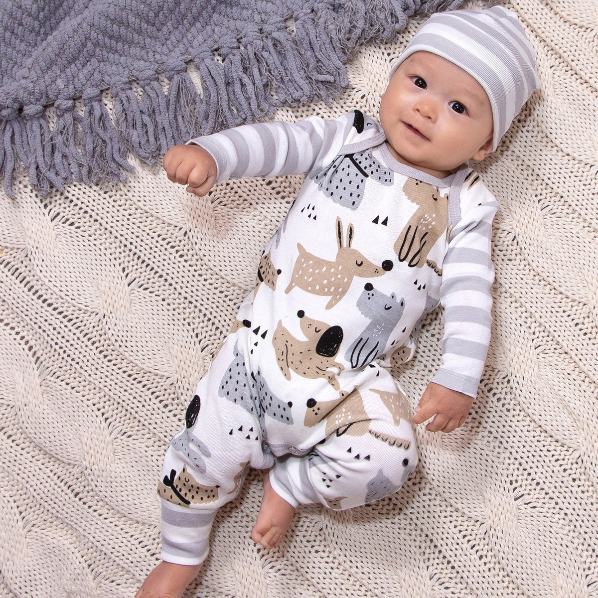 White romper with puppy dog print and gray striped sleeves, front overalls style