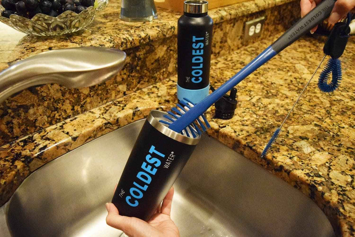 3-in-1 bottle brush with blue bristles and slender cleaning handle by a sink