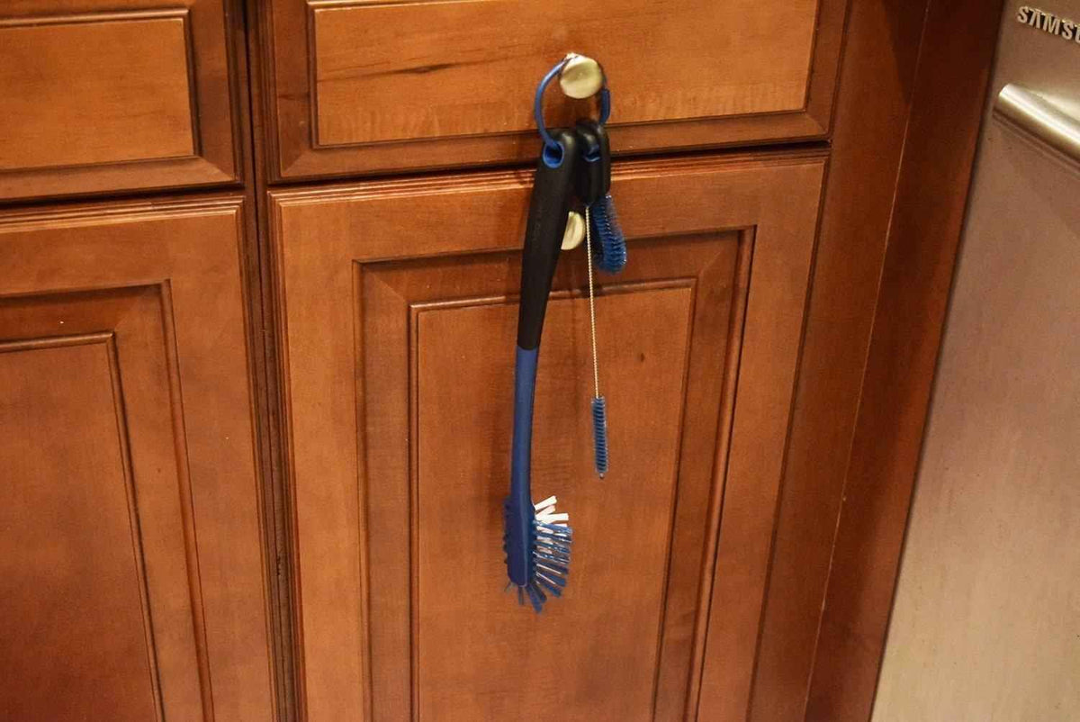 3-in-1 bottle brush hanging by loop with blue bristles and blue-black handle