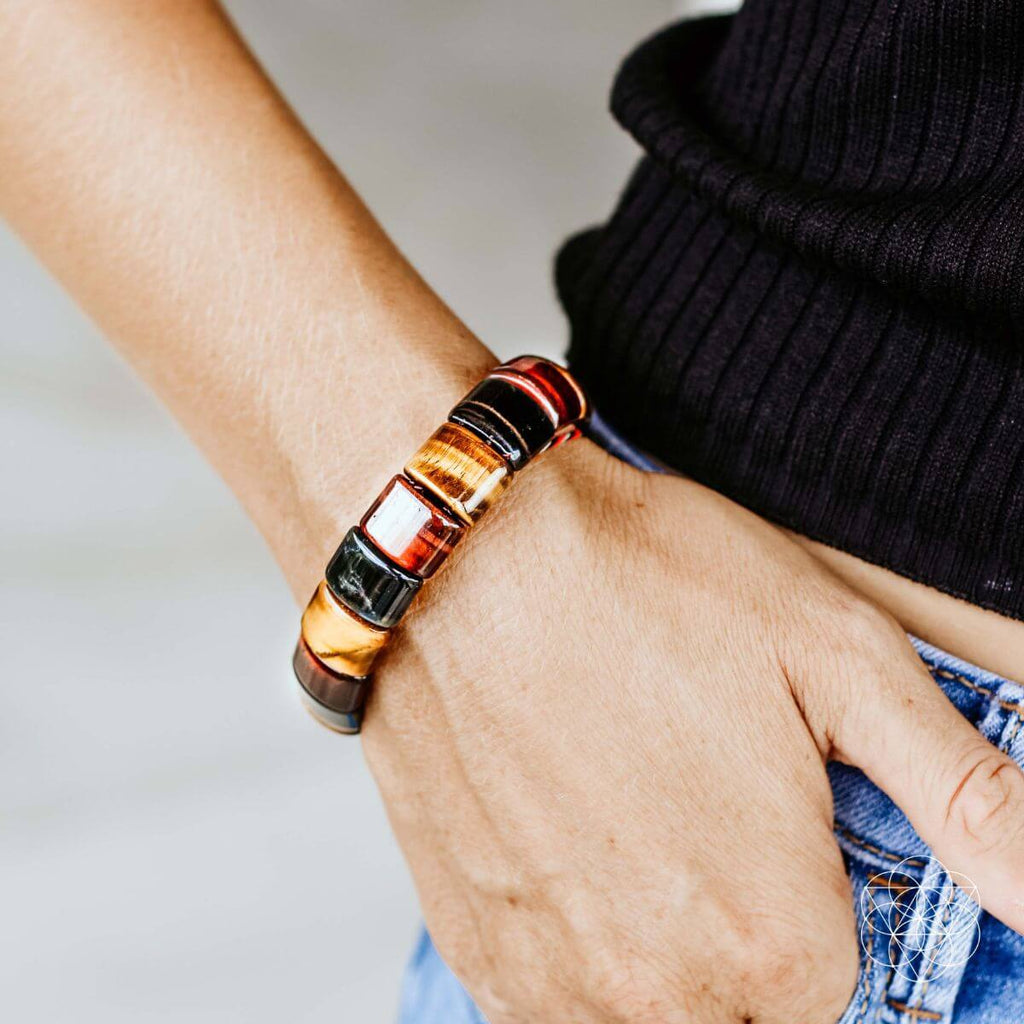 Multicolor barrel-bead bracelet on wrist, shown with dark knit sleeve