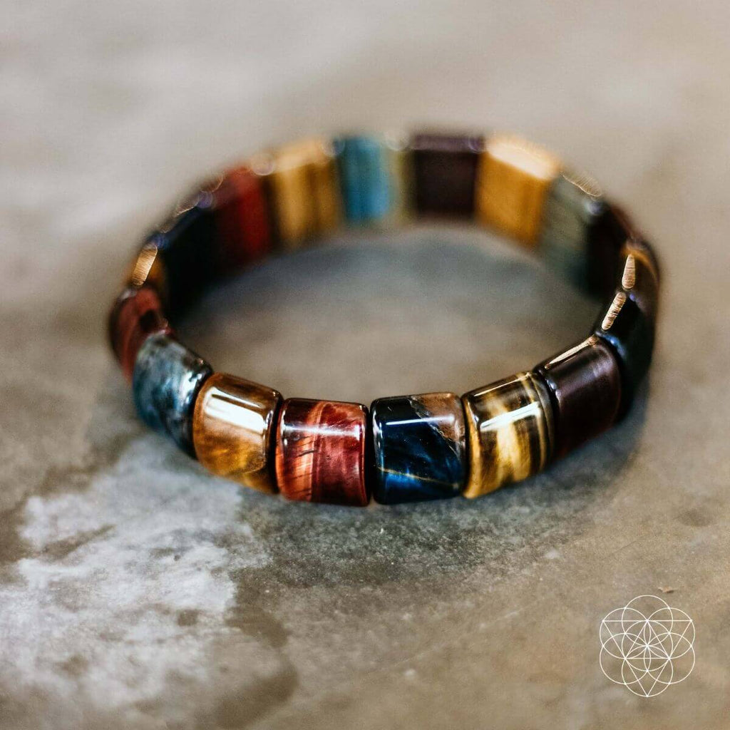 Multicolor barrel-bead bracelet with blue, red, gold, and dark accents