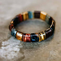 Multicolor barrel-bead bracelet with blue, red, gold, and dark accents