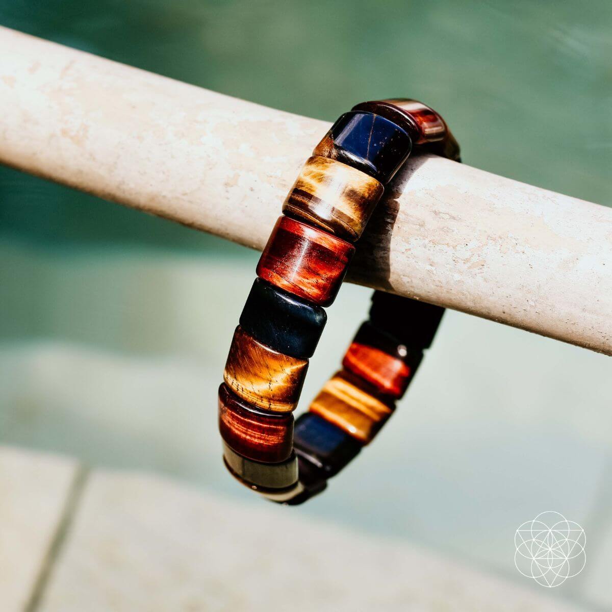 Close-up of multicolor barrel-bead bracelet with blue, red, and gold rings