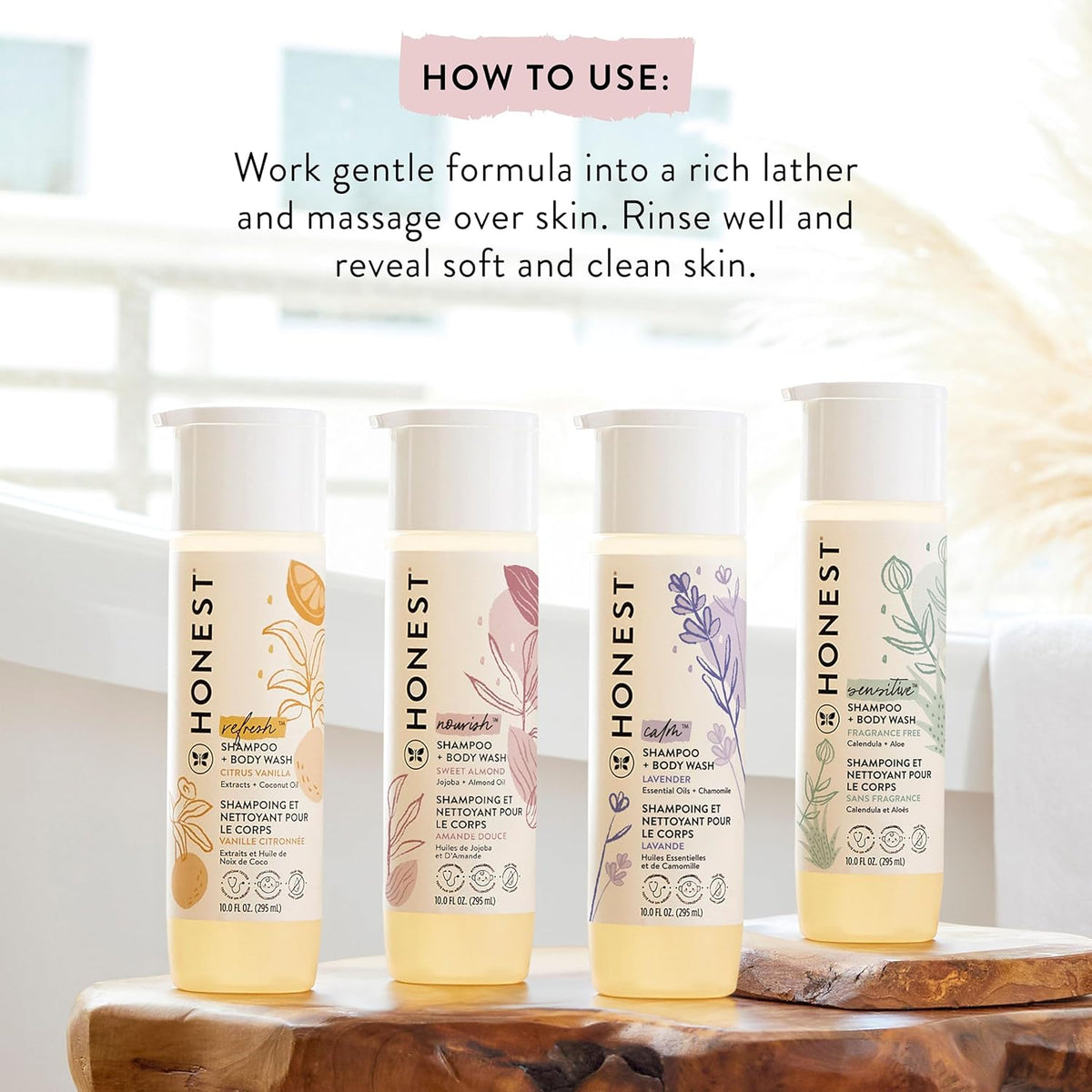 Honest 2-in-1 shampoo & body wash bottles in a row on wooden tray