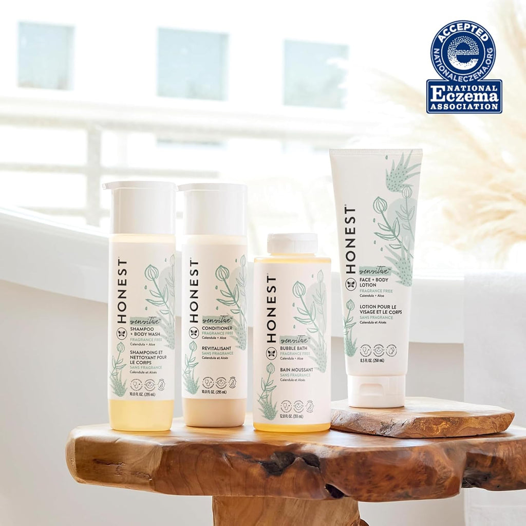 Set of Honest 2-in-1 shampoo & body wash bottles on wooden stand