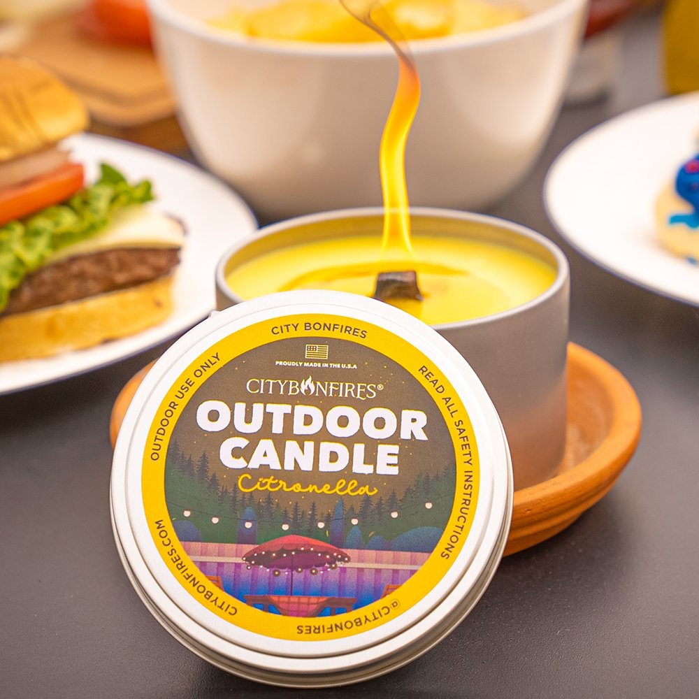Outdoor citronella candle metal tin with burning wick and yellow wax