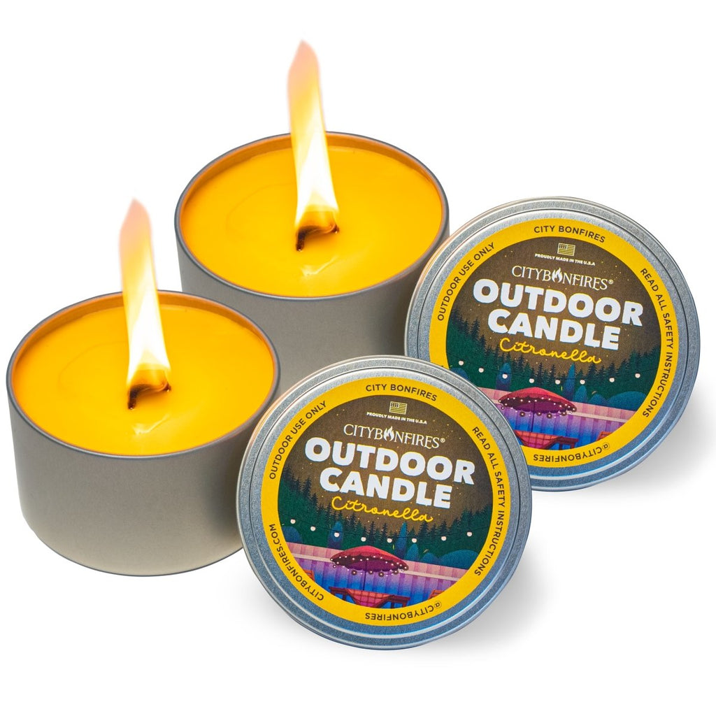 Outdoor citronella candles with lit flames and metal tins, arranged together