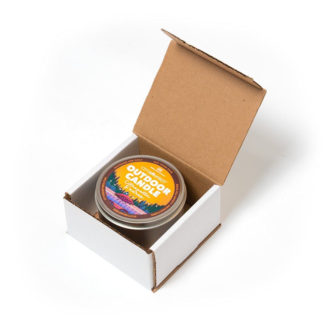 Outdoor citronella candle in metal tin with lid, packed in open cardboard box, s'mores