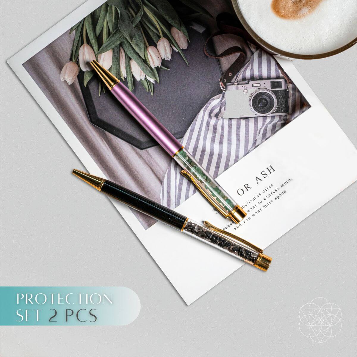 Protection set crystal pen with gold details and pink barrel, resting on stationery
