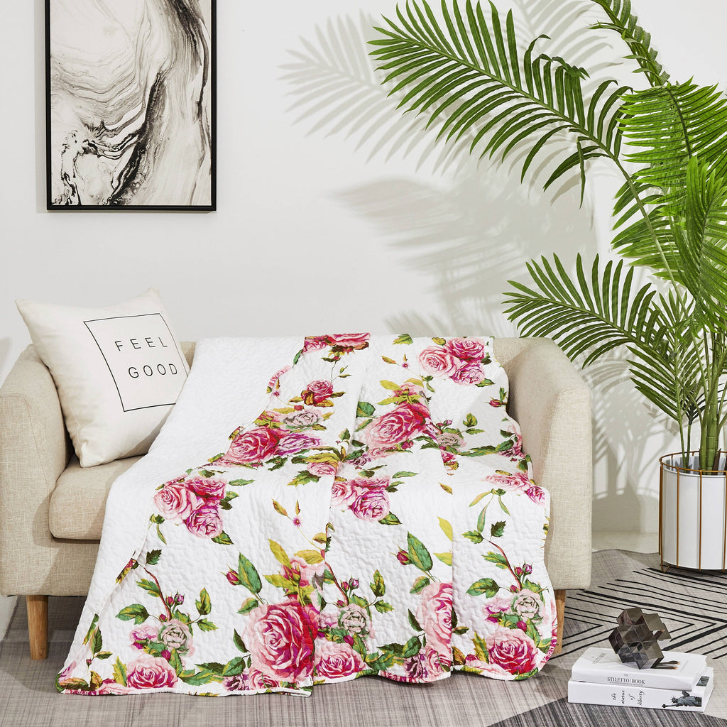 Quilted rose floral throw blanket with white background and pink blossoms