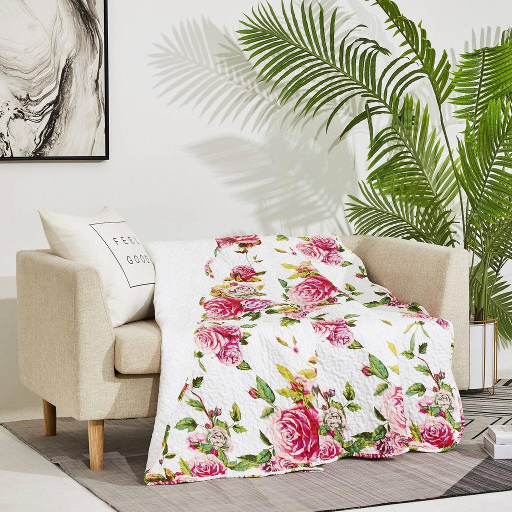 White quilted throw blanket with pink roses and green foliage floral print