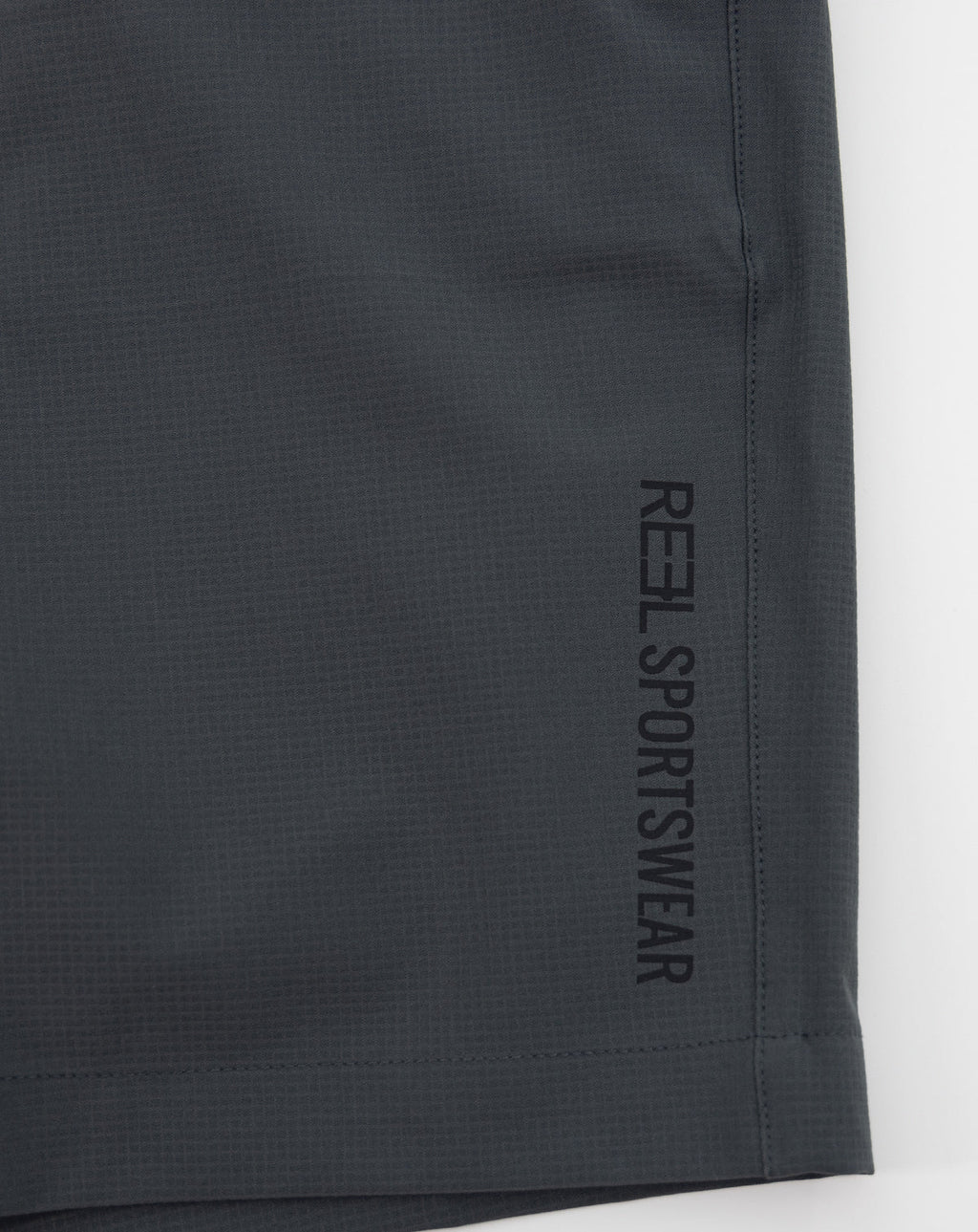 Dark gray REEL sportswear shorts with vertical side branding