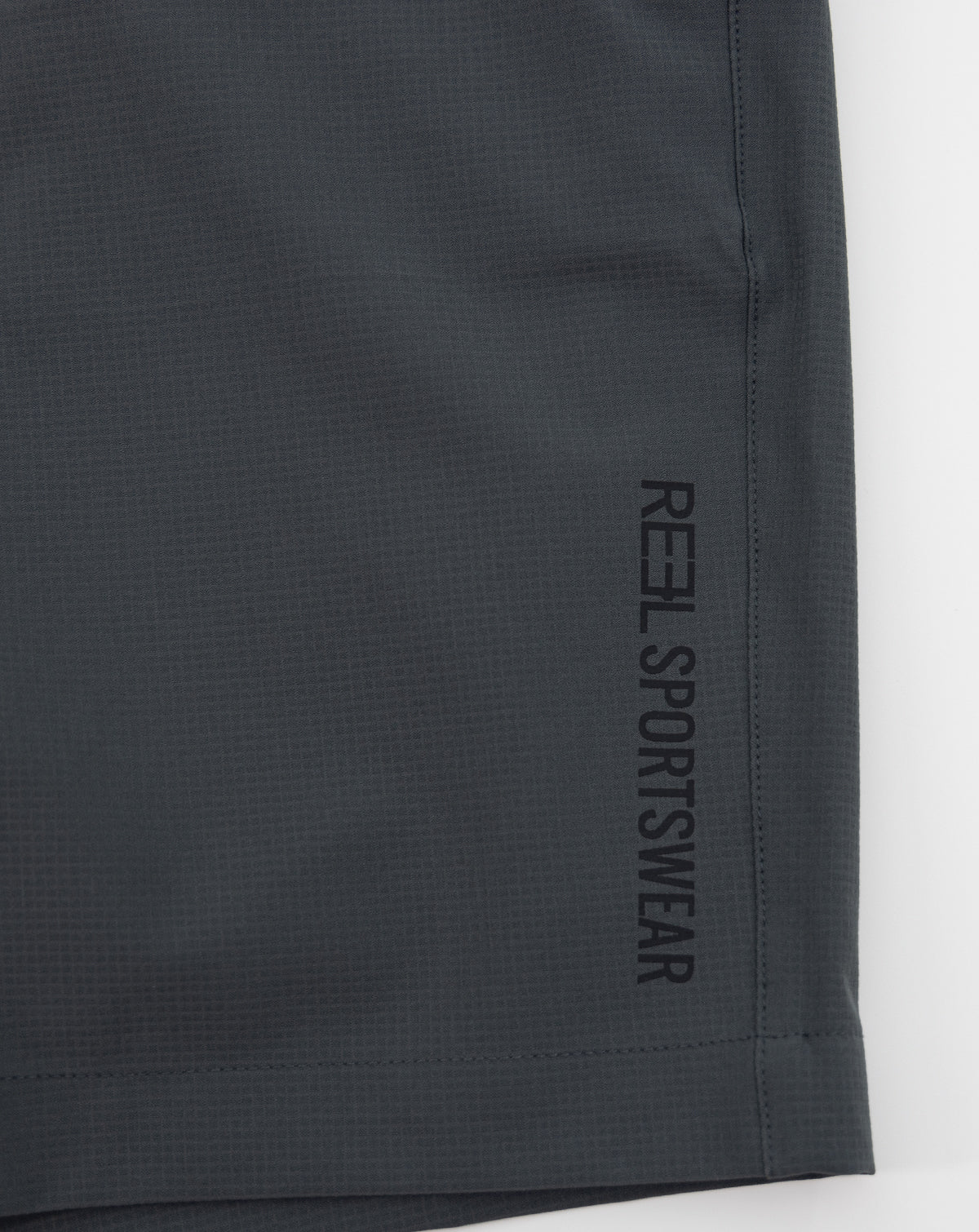 Dark gray REEL sportswear shorts with vertical side branding