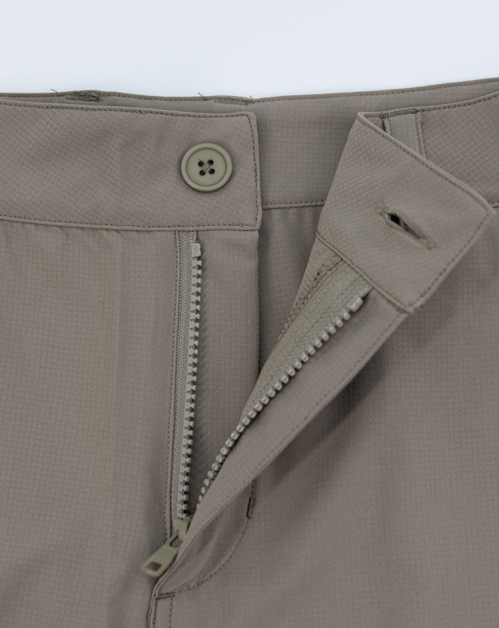 Khaki shorts with side pocket opening and exposed zipper at fly