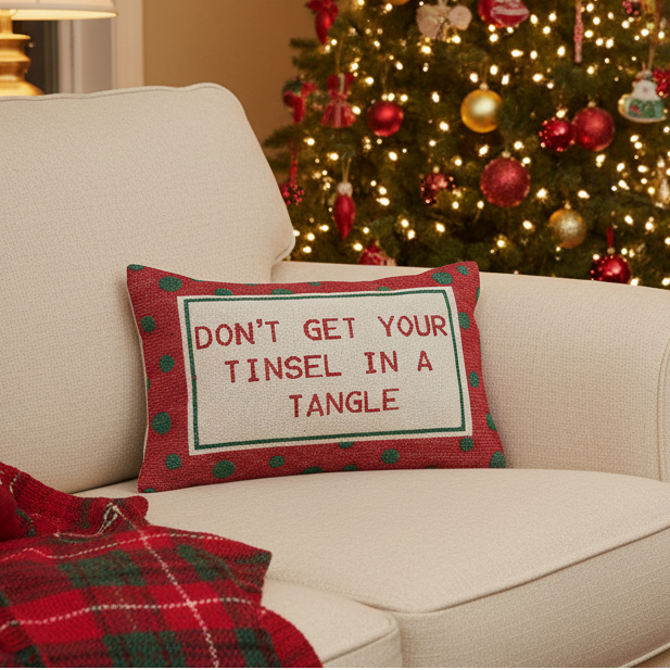 Red cotton lumbar pillow with green polka dots and 'DON'T GET YOUR TINSEL IN A TANGLE' quote