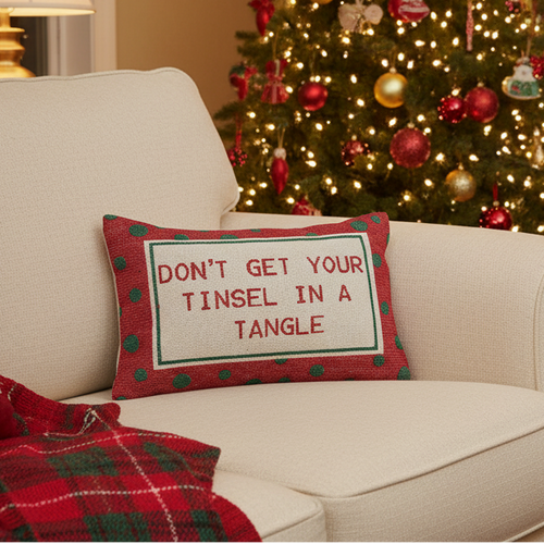 Red cotton lumbar pillow with green polka dots and 'DON'T GET YOUR TINSEL IN A TANGLE' quote