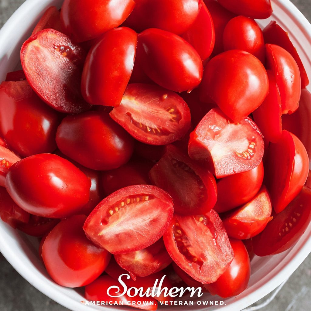 Sliced red Roma tomatoes in a white bowl
