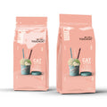 Touchcat clumping cat litter in two pink bags with litter scoop graphics