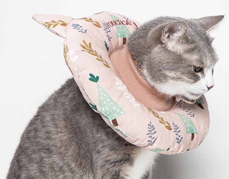 Pink Touchcat Ringlet cat neck protector pillow worn by a cat, with a padded ring and cat-ear points