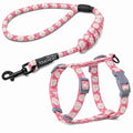 Pink floral cat harness and leash set with gray buckles and black leash clip.