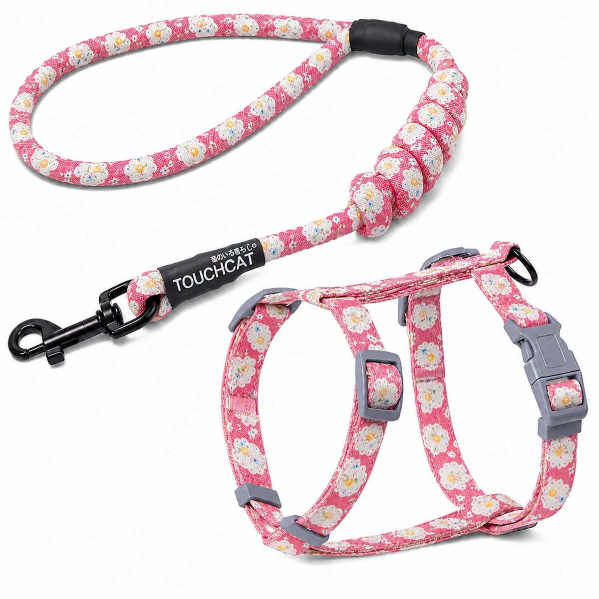 Pink floral cat harness and leash set with gray buckles and black leash clip.
