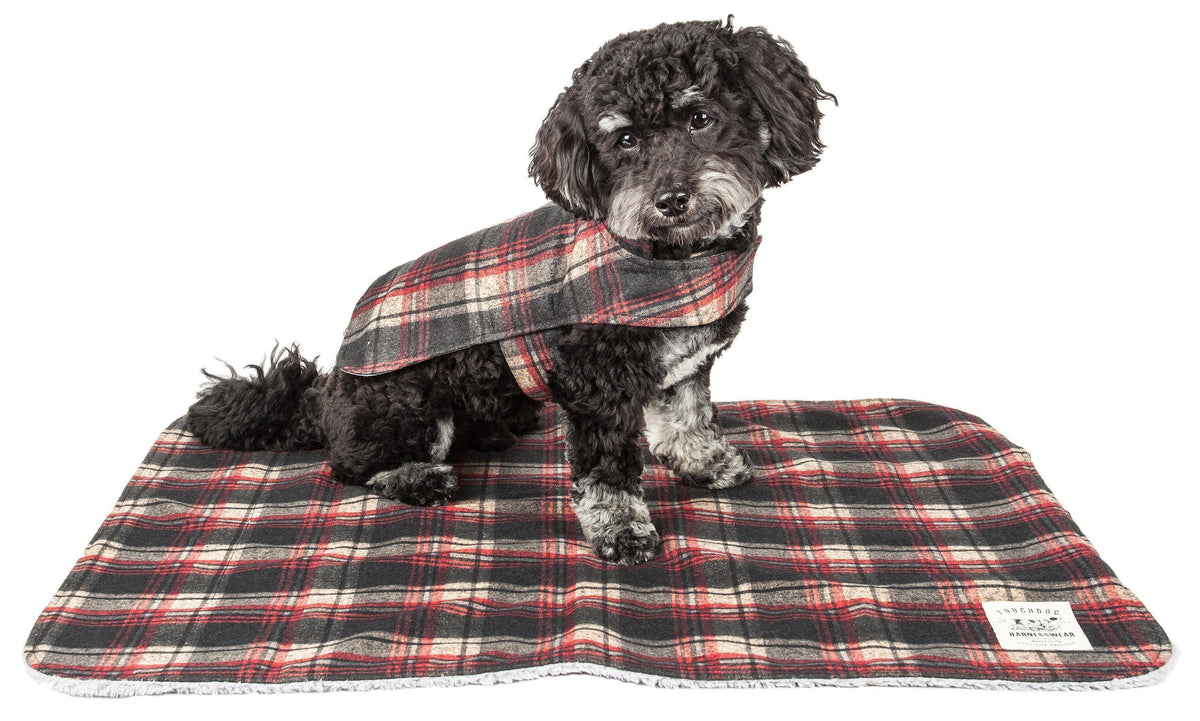 Dark red plaid dog jacket modeled with its matching mat.