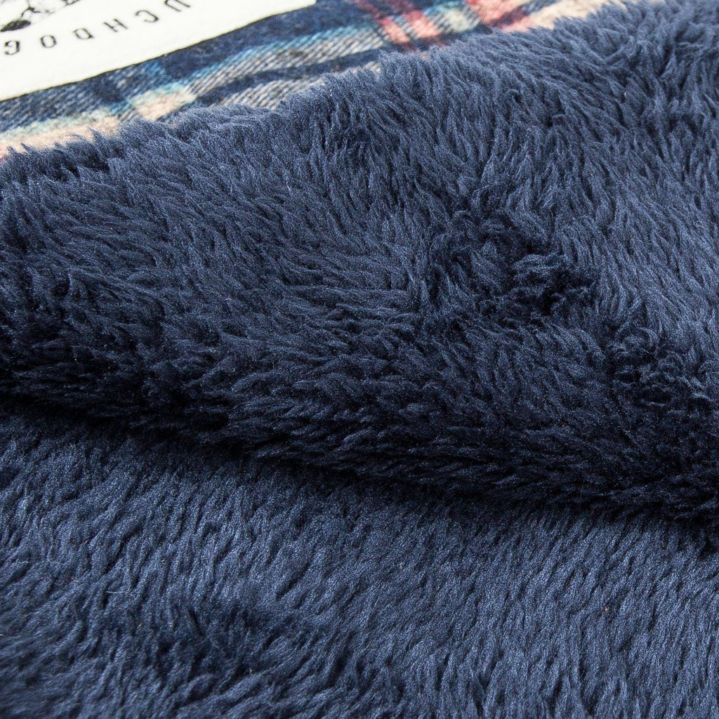 Reversible dog mat with a plush navy surface and tartan plaid edge