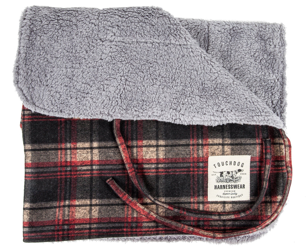 Dark red plaid reversible dog mat folded to show its light gray plush lining.
